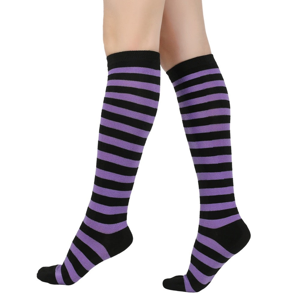Black and purple femboy pin striped knee-high socks on a white background
