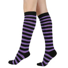 Black and purple femboy pin striped knee-high socks on a white background