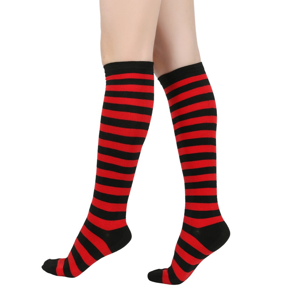 Red and black femboy pin striped knee-high socks on a white background