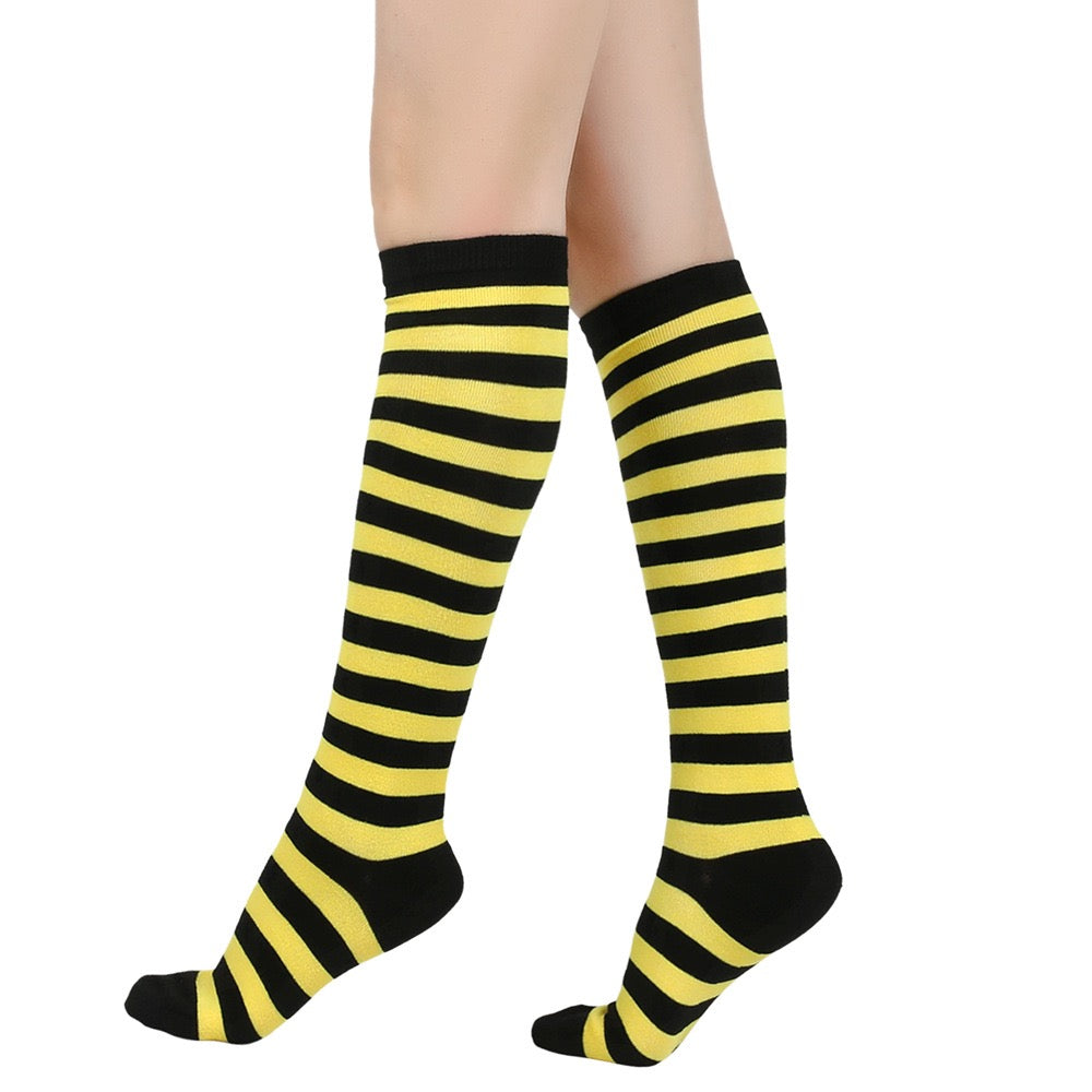 Black and yellow femboy striped knee-high socks on a white background