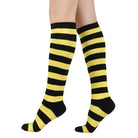 Black and yellow femboy striped knee-high socks on a white background