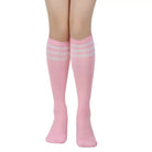 Pink knee-high socks with white stripes worn by a femboy on a white background
