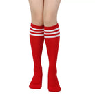 Red knee-high socks with white stripes worn by a femboy on a white background