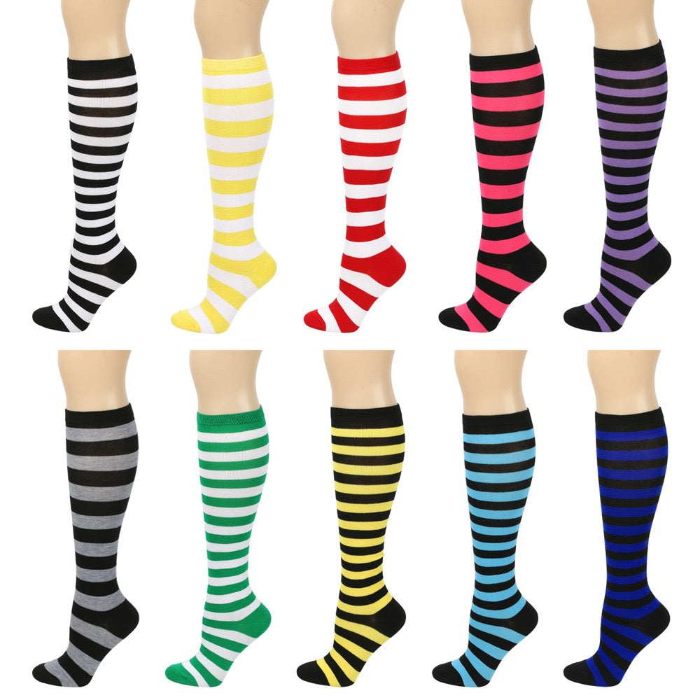 Set of colorful striped knee-high socks on a white background
