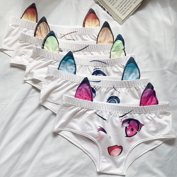 Set of white underwear with colorful cat ear and eye designs on a white background.
