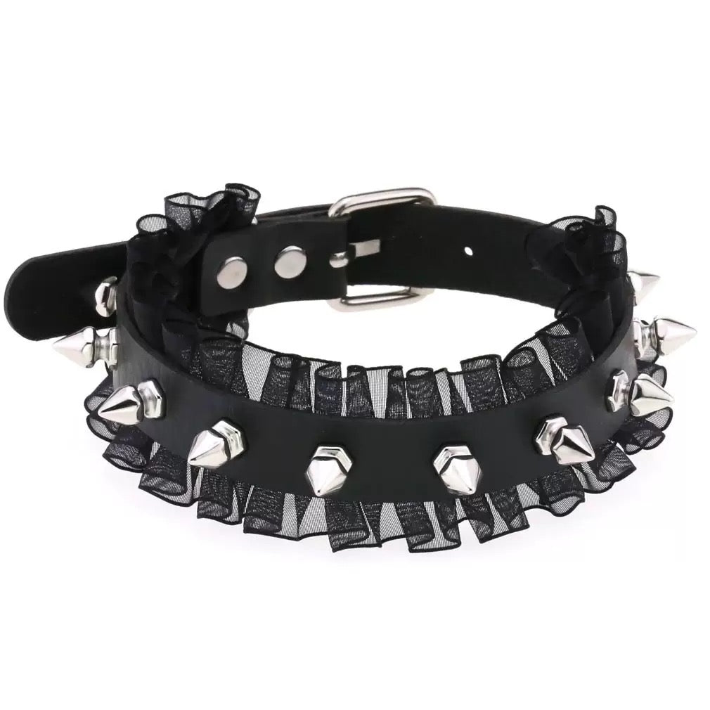 Black choker with sheer fabric and silver studs on a white background