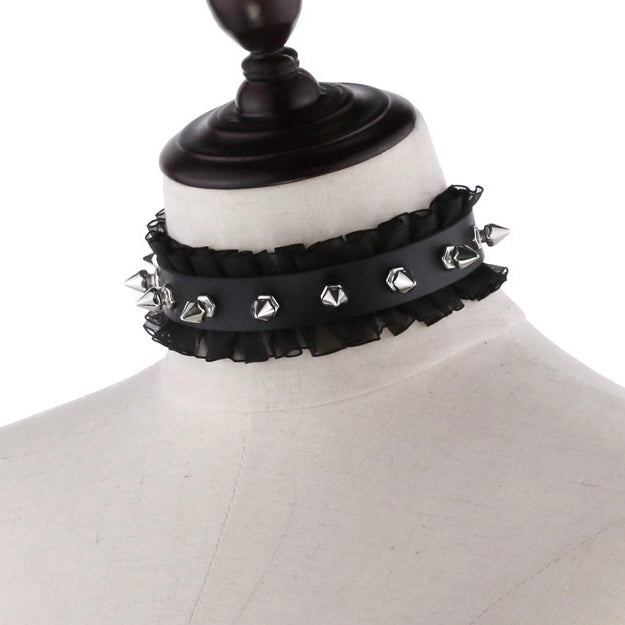 Black choker with silver studs on a mannequin head.