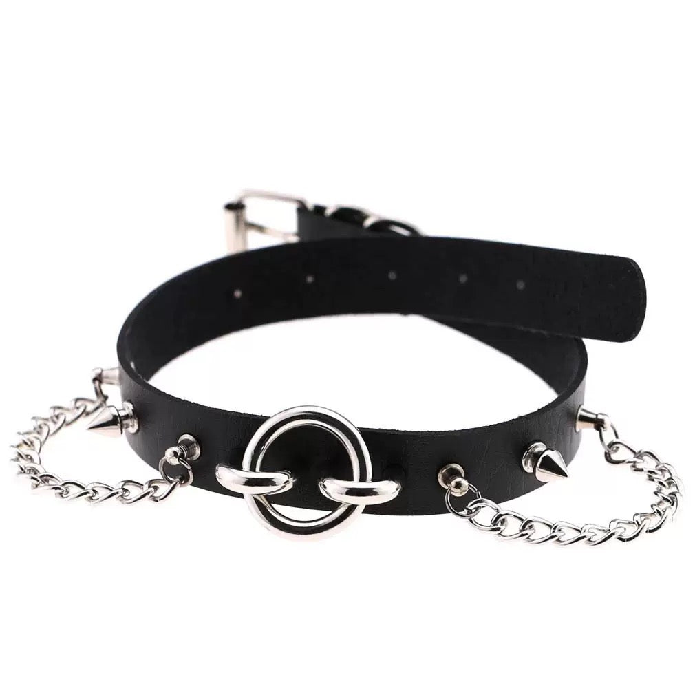 Black leather choker with silver chain and rings on a white background