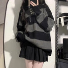 Femboy wear a gray and black oversize sweater