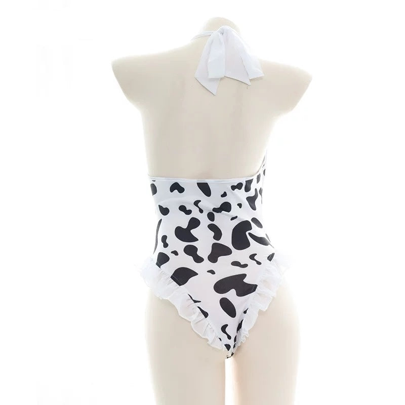 White and black halter cow print bodysuit lingerie on a mannequin against a white background