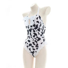 halter cow print bodysuit lingerie with black and white pattern on a mannequin against a white background