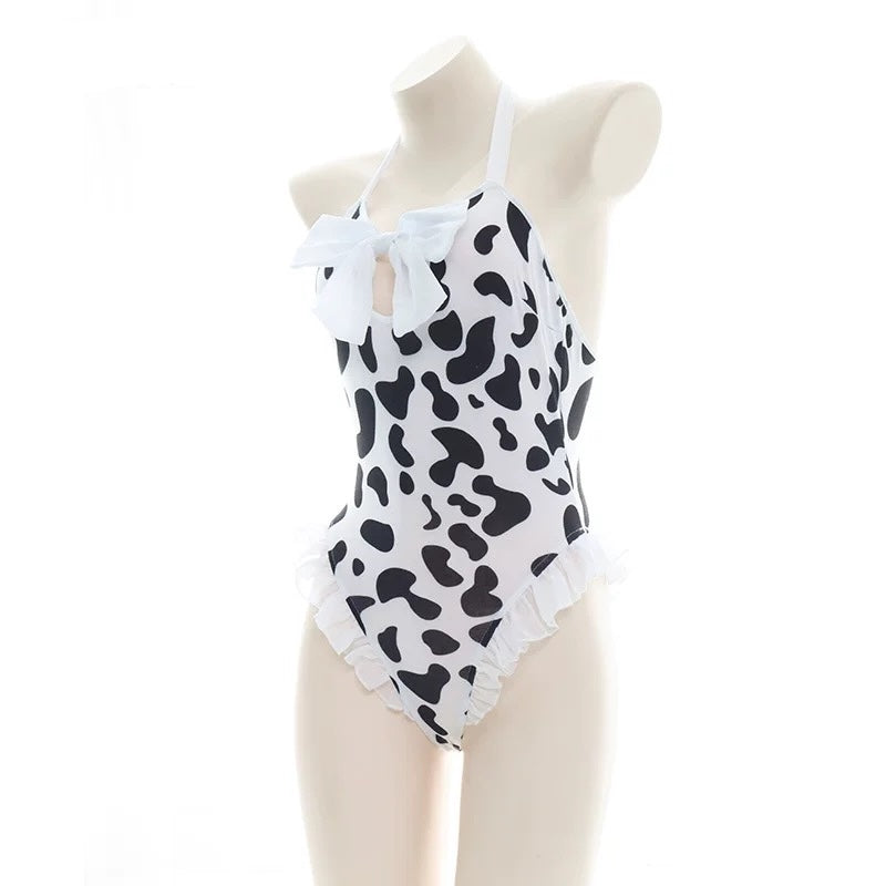 halter cow print bodysuit lingerie with black and white pattern on a mannequin against a white background