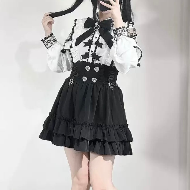 Person wearing a black and white outfit with a black skirt and white top.