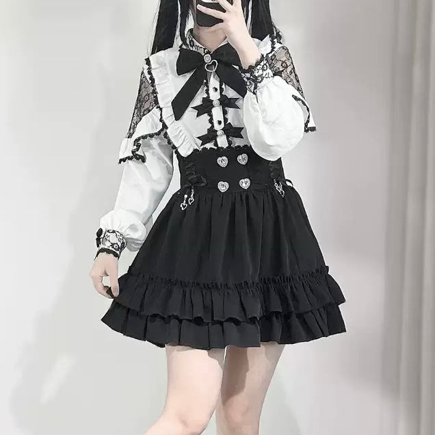 Person wearing a black and white outfit with a black skirt and white blouse.