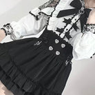 Black and white dress with lace details on a plain background