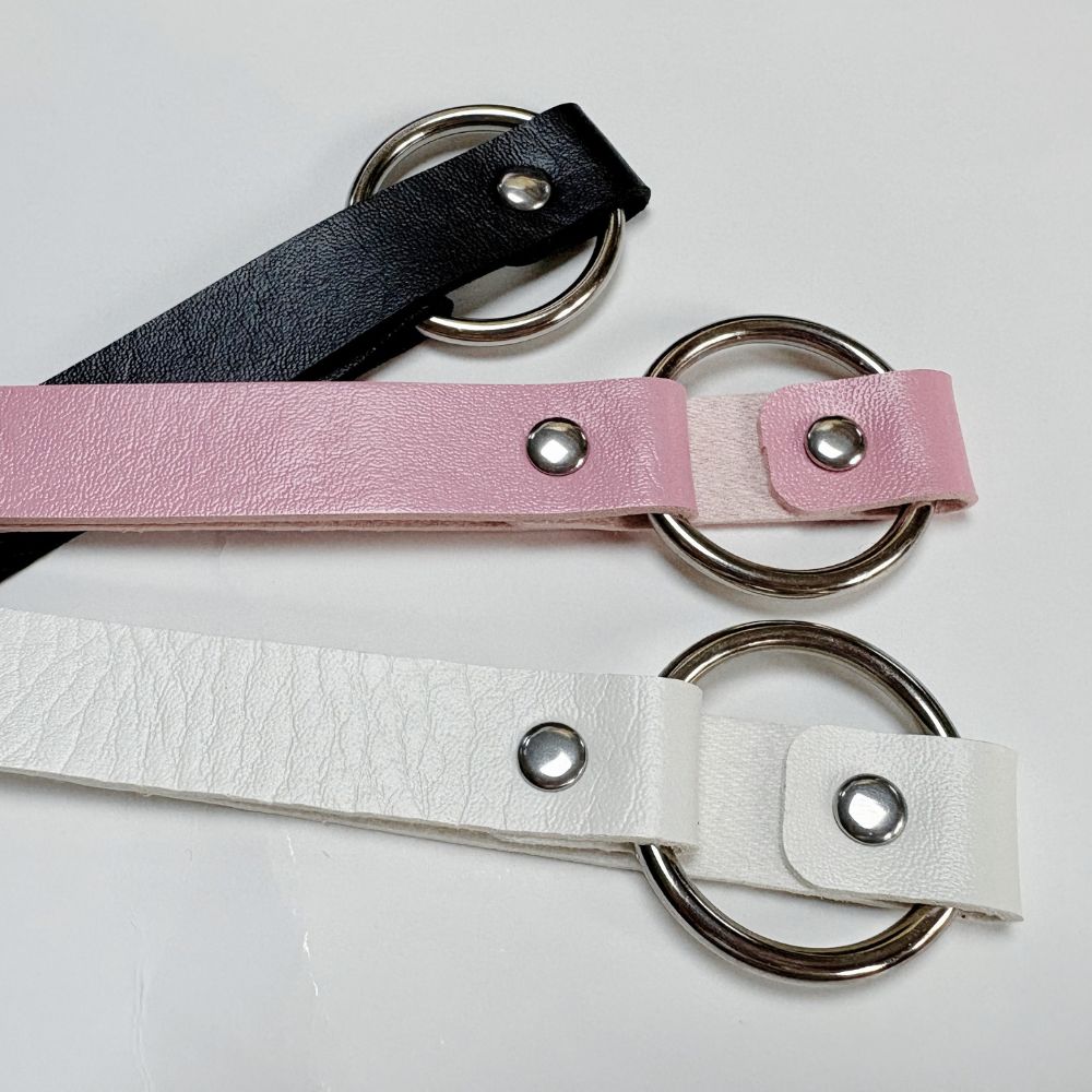 Three leather o ring choker on a light gray background