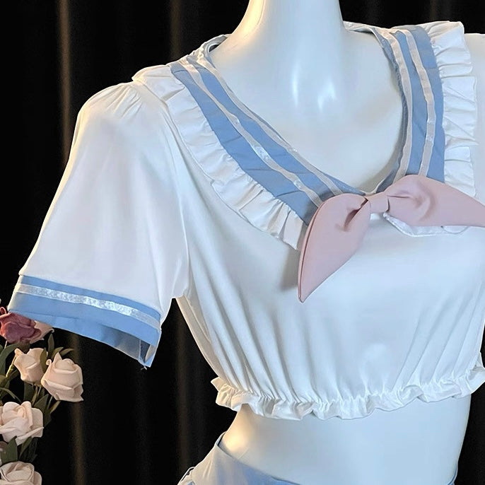 White dress with blue trim on a mannequin against a black background