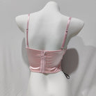 Pink bra on a mannequin against a gray background