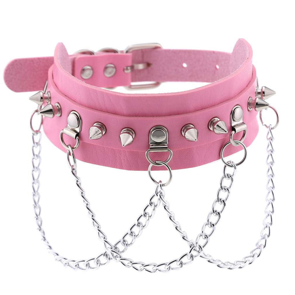 Pink leather collar with silver spikes and chains on a white background