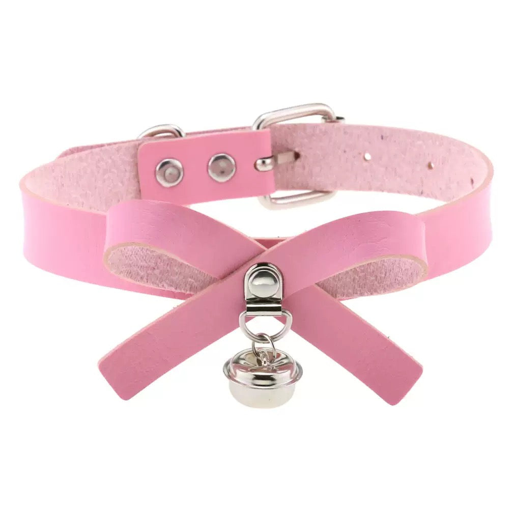 Pink leather choker with silver clasp and bell on a white background