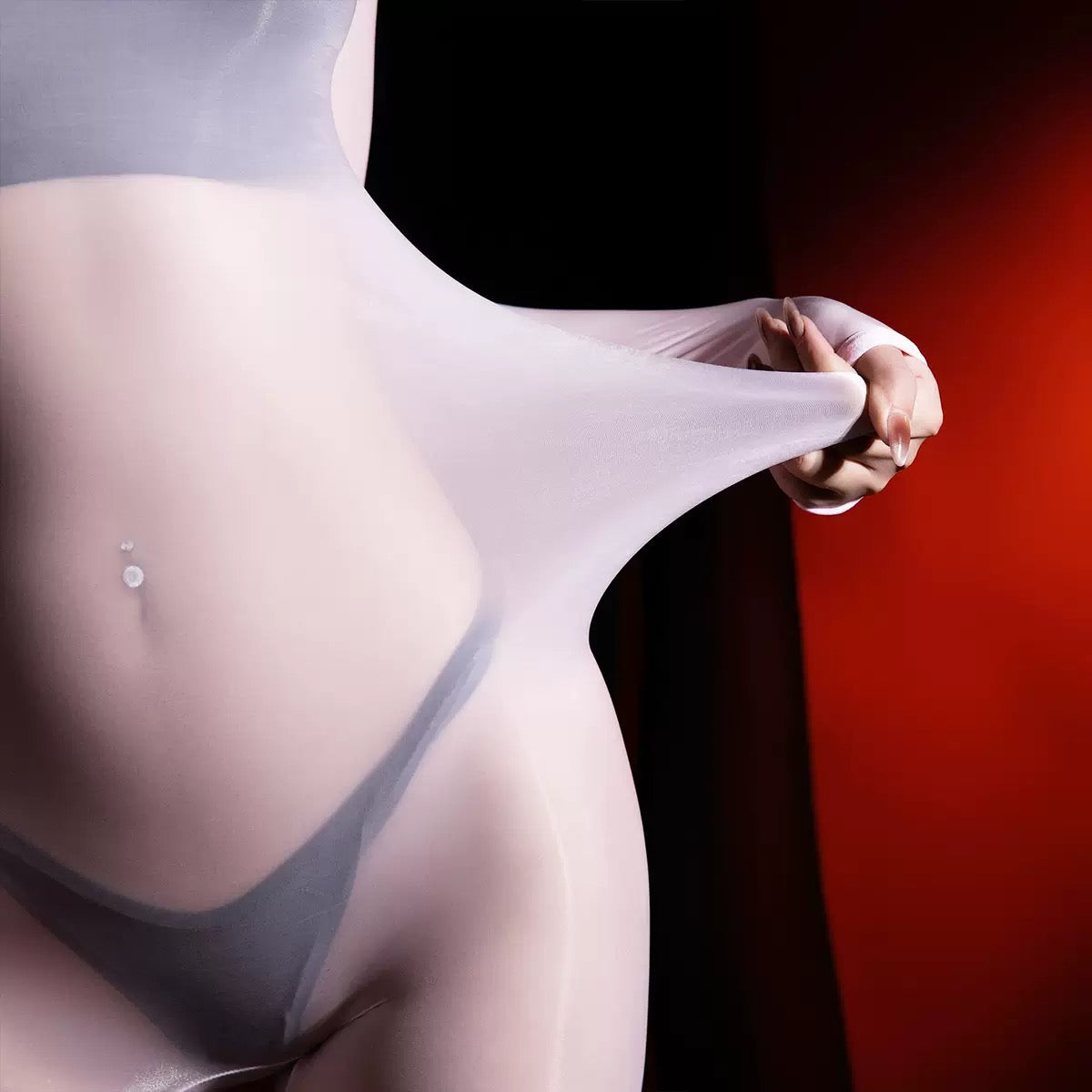 Close-up of a person wearing sheer white stockings with a dark background