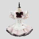 Pink and white dress with a large brown bow on a mannequin against a light gray background