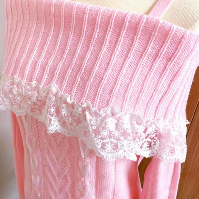 A close-up of a pink ribbed knit sweater with a white floral lace trim along the neckline, displayed on a mannequin torso.