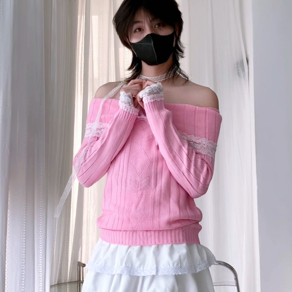 A femboy wearing a pink off-the-shoulder cable-knit sweater with white lace trim on the cuffs and hem, paired with a white ruffled skirt, standing in front of white curtains.