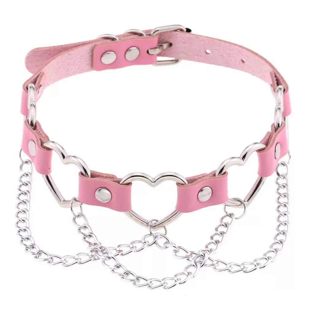 Pink leather collar with silver chain on a white background