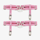 Pink leather leg garters with silver pentagram design on a white background