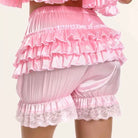 Pink sweet ruffled bloomer short with lace details on a white background