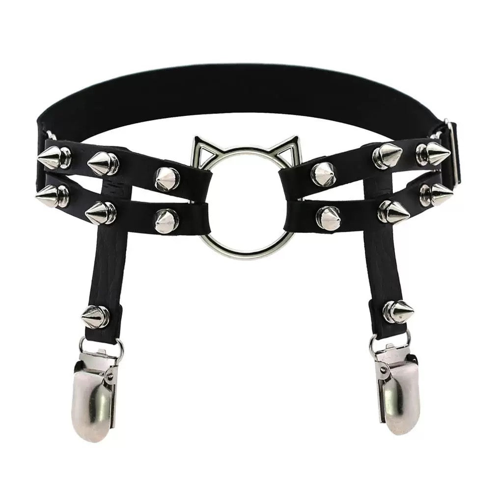 Black leg garters with cat ears and spikes on a white background