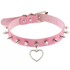 Pink leather choker with silver spikes and a heart-shaped charm on a white background