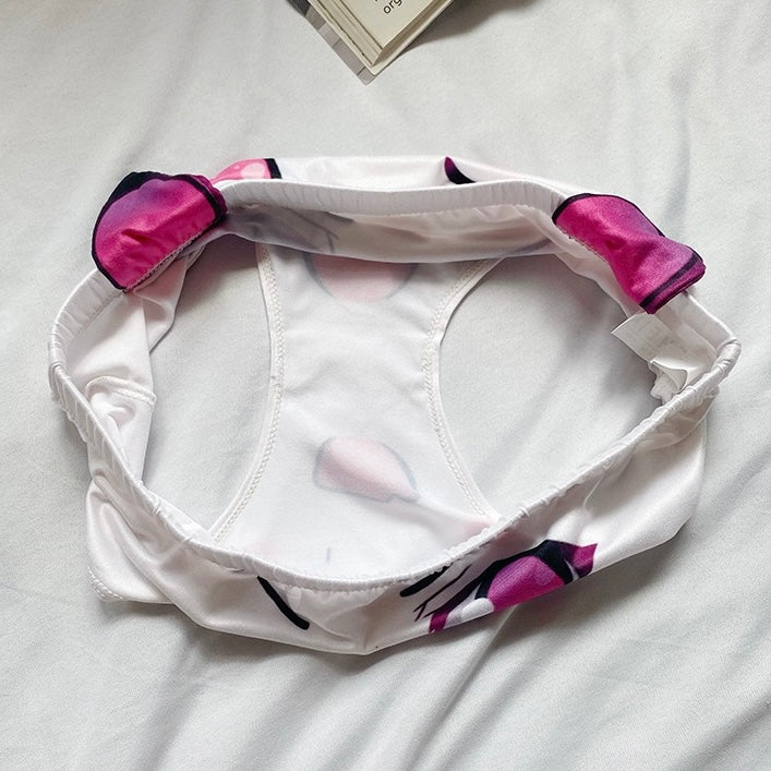 White headband with pink and black accents on a light gray background