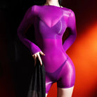 Person wearing a shiny purple long sleeve body stocking romper