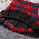 Plaid skirt with red and blue pattern on a textured surface