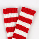 Red and white striped arm warmers on a light gray background