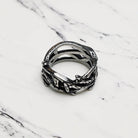 Silver retro thorns stainless steel ring on a marble surface
