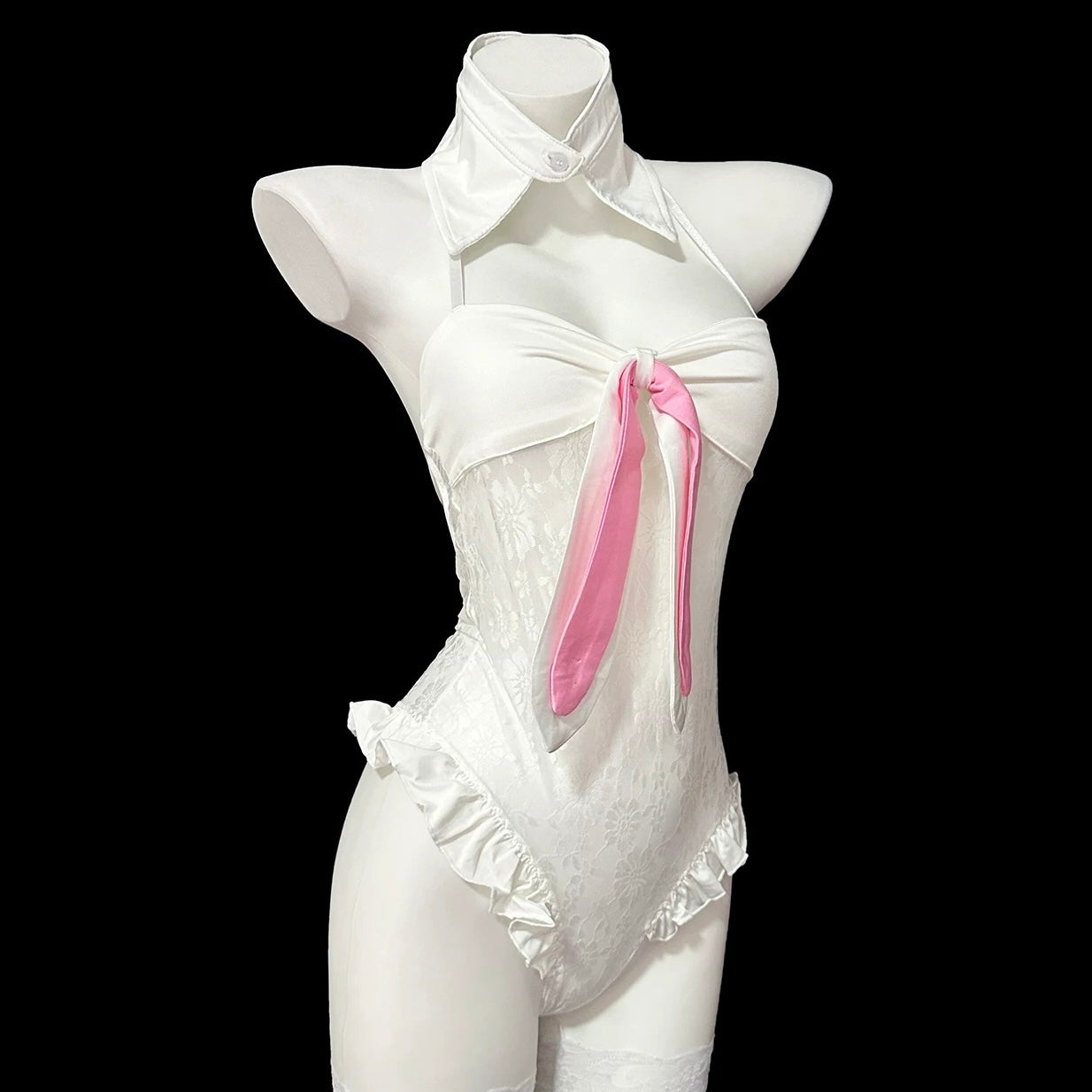 Person wearing a black and white bunny costume with fishnet stockings against a light gray background.