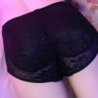 Black floral-patterned underwear on a mannequin against a pink floral background