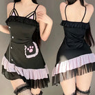 Black apron dress with pink paw print design on a gray background