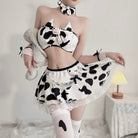 Person wearing a cow print outfit with a white background