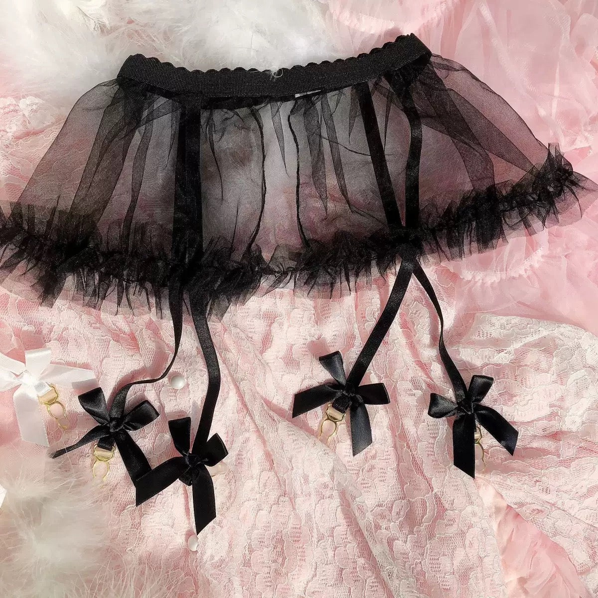 Black tulle petticoat with decorative bows on a pink floral background