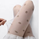 Beige tights with paw print pattern worn by a person on a white background