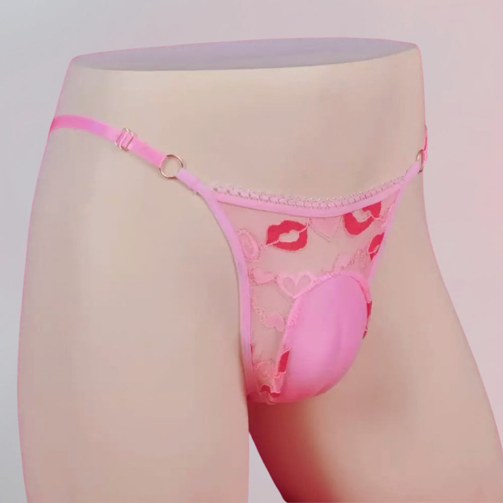 Pink lace thong with heart and kiss mark design on a mannequin against a light gray background