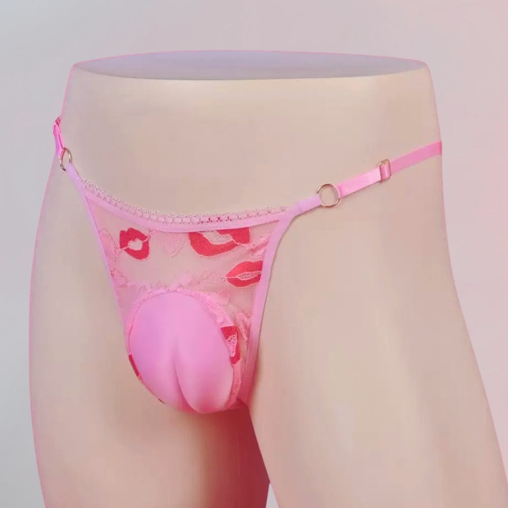 Pink lace thong with floral design on a mannequin against a light gray background
