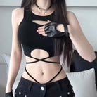 Person wearing a black outfit with cut-out design and leather gloves.