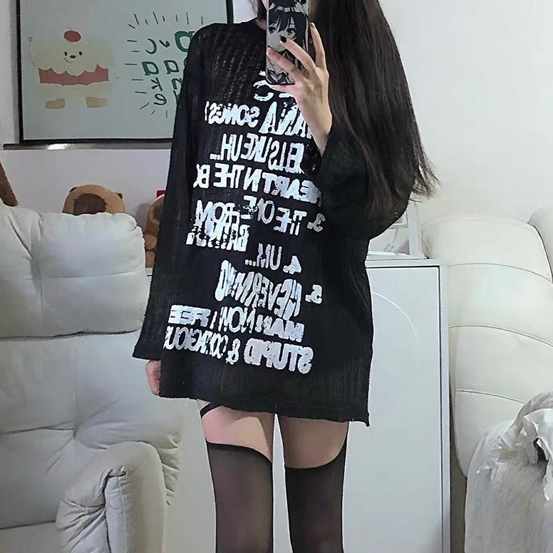 Black outfit with sheer sleeves and layered skirt on a white background