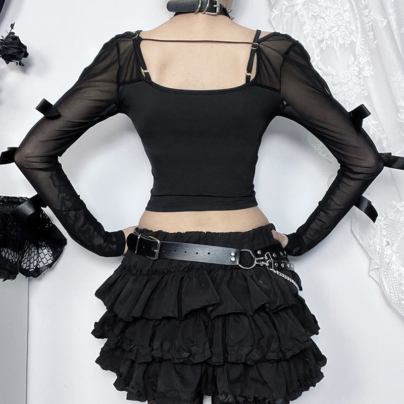 Black outfit with sheer sleeves and layered skirt on a white background