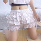 Person wearing a white sweet lolita bloomers on a light background